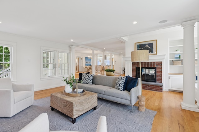 22 Channel Cove Ln, Biddeford, ME 04005 - living room with ornate columns, light wood-type flooring, recessed lighting, a brick fireplace, and ornamental molding