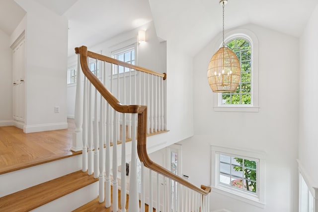 22 Channel Cove Ln, Biddeford, ME 04005 - stairway featuring a chandelier, plenty of natural light, wood finished floors, and lofted ceiling