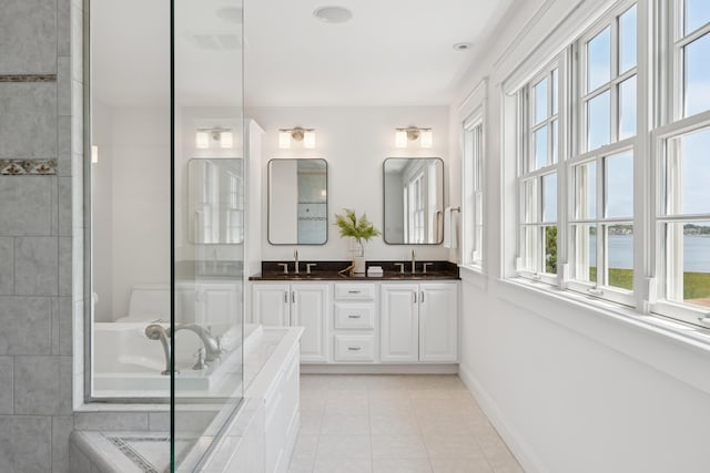 22 Channel Cove Ln, Biddeford, ME 04005 - full bath with double vanity, healthy amount of natural light, a bath, and tile patterned flooring
