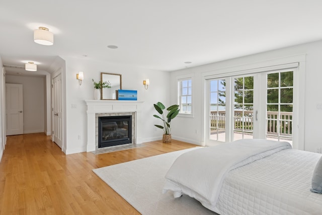 22 Channel Cove Ln, Biddeford, ME 04005 - bedroom featuring access to outside, light wood-type flooring, and a fireplace
