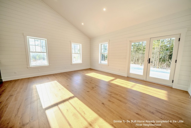 5 Whitetail St, Belfast, ME 04915 - empty room featuring french doors, light wood-style flooring, lofted ceiling, wood walls, and recessed lighting