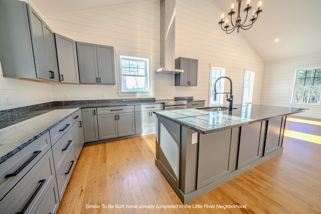 5 Whitetail St, Belfast, ME 04915 - kitchen with lofted ceiling, gray cabinets, light wood-style floors, a chandelier, and dark stone counters
