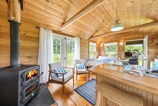 1535 Bailey Rd, Knox, ME 04986 - office space with wood ceiling, light wood-type flooring, wooden walls, and a wood stove