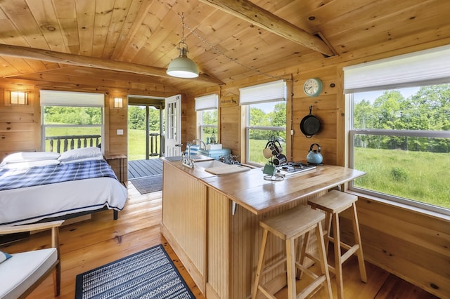 1535 Bailey Rd, Knox, ME 04986 - bedroom with light wood-type flooring, wooden walls, access to exterior, and wooden ceiling