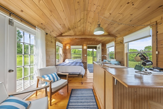 1535 Bailey Rd, Knox, ME 04986 - bedroom featuring vaulted ceiling, wooden walls, light wood-style floors, and wood ceiling