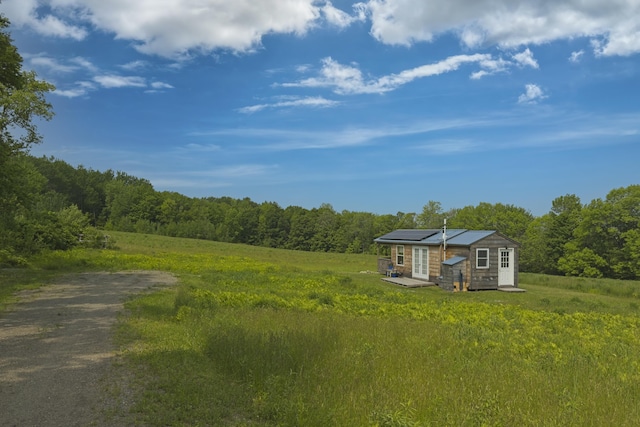 1535 Bailey Rd, Knox, ME 04986 - view of yard with a view of trees, french doors, a deck, and dirt driveway