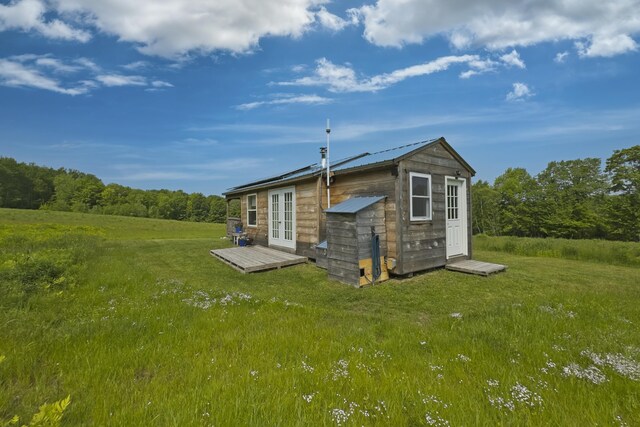 1535 Bailey Rd, Knox, ME 04986 - back of house featuring french doors, an outdoor structure, a yard, and a metal roof