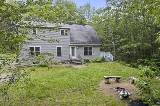 47 Double M Ln, Woolwich, ME 04579 - back of property with a lawn and a wooden deck