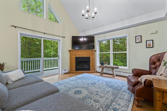 47 Double M Ln, Woolwich, ME 04579 - living area with baseboard heating, a chandelier, plenty of natural light, and high vaulted ceiling