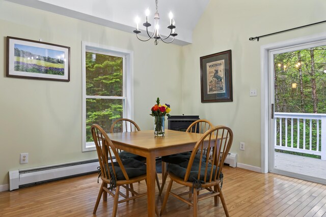 47 Double M Ln, Woolwich, ME 04579 - dining area featuring a baseboard heating unit, light wood-style flooring, healthy amount of natural light, a chandelier, and vaulted ceiling