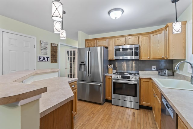 47 Double M Ln, Woolwich, ME 04579 - kitchen featuring appliances with stainless steel finishes, light countertops, decorative backsplash, and light wood-style flooring