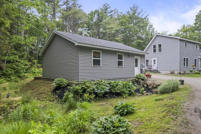 47 Double M Ln, Woolwich, ME 04579 - view of front of house featuring roof with shingles and dirt driveway