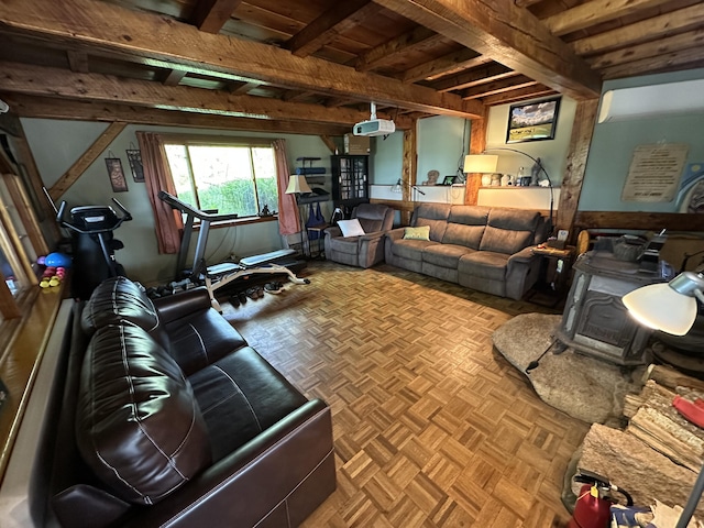 396 Smyrna Town Line Rd, Smyrna, ME 04780 - living room with beamed ceiling and a wood stove
