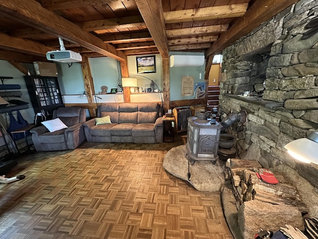 396 Smyrna Town Line Rd, Smyrna, ME 04780 - living room with a wooden ceiling with exposed beams, an AC wall unit, and a wood stove