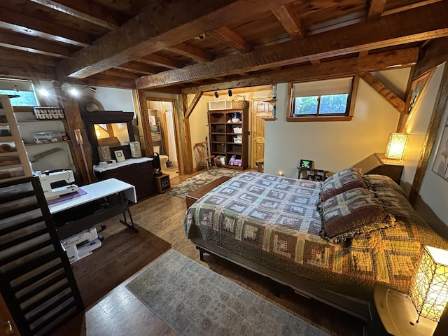 396 Smyrna Town Line Rd, Smyrna, ME 04780 - bedroom with wood finished floors and beam ceiling