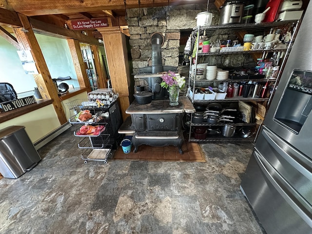 396 Smyrna Town Line Rd, Smyrna, ME 04780 - interior space featuring a wood stove and stainless steel refrigerator with ice dispenser