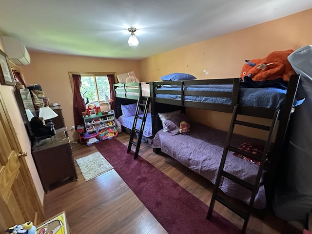 396 Smyrna Town Line Rd, Smyrna, ME 04780 - bedroom with wood finished floors and a wall mounted air conditioner