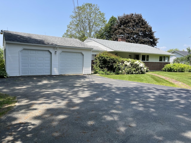 241 Bristol Rd, Damariscotta, ME 04543 - ranch-style house with driveway, a garage, a chimney, and a front yard