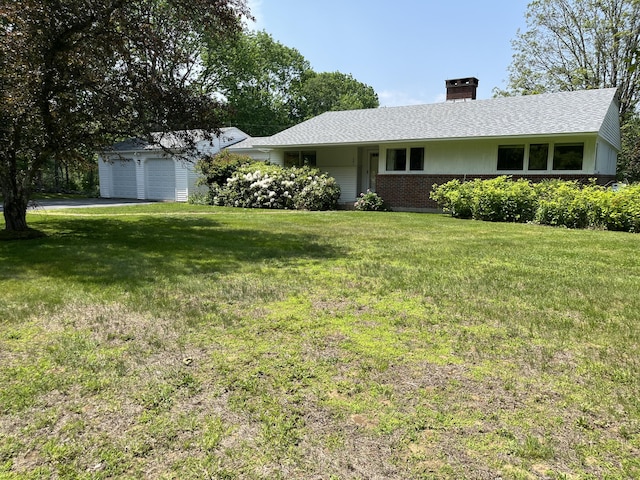 241 Bristol Rd, Damariscotta, ME 04543 - view of front of home featuring a front lawn, a chimney, driveway, and brick siding