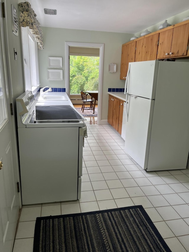 241 Bristol Rd, Damariscotta, ME 04543 - laundry area with light tile patterned floors and washer and clothes dryer