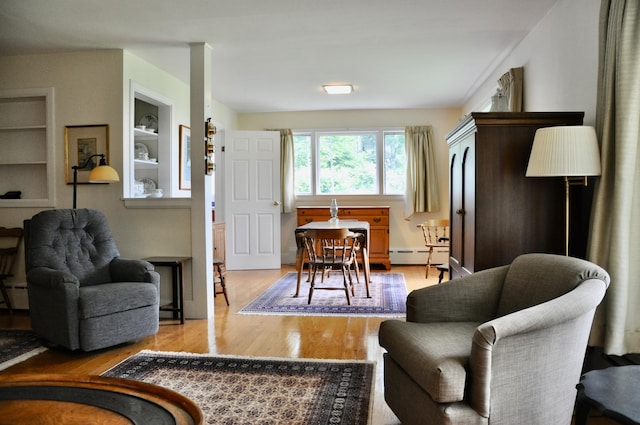 241 Bristol Rd, Damariscotta, ME 04543 - living area with baseboard heating, light wood-type flooring, and built in shelves