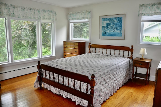 241 Bristol Rd, Damariscotta, ME 04543 - bedroom with multiple windows, light wood finished floors, and a baseboard radiator