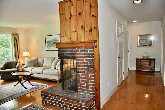 241 Bristol Rd, Damariscotta, ME 04543 - living area with a brick fireplace and hardwood / wood-style floors