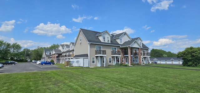 35 Mathews Ave Unit 6, Waterville, ME 04901 - view of front of house featuring uncovered parking, a front yard, a residential view, and a shingled roof