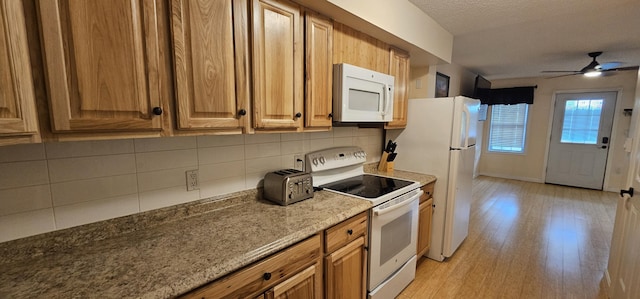 35 Mathews Ave Unit 6, Waterville, ME 04901 - kitchen with white appliances, light wood finished floors, backsplash, a ceiling fan, and stone countertops