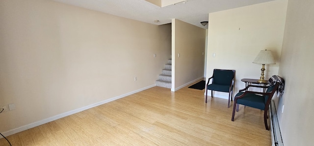 35 Mathews Ave Unit 6, Waterville, ME 04901 - sitting room with light wood-type flooring, stairway, and a baseboard heating unit
