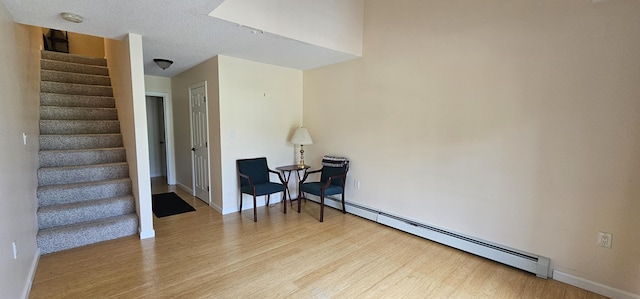 35 Mathews Ave Unit 6, Waterville, ME 04901 - living area featuring a baseboard heating unit, wood finished floors, and stairs