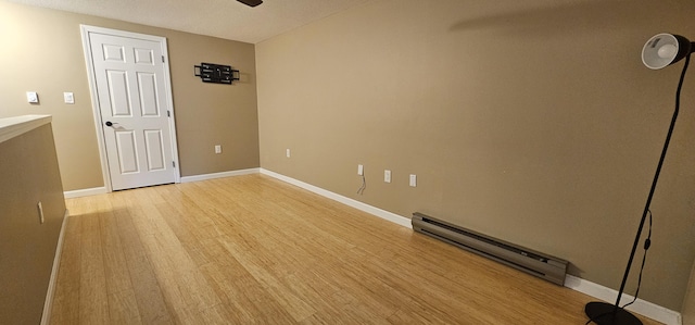 35 Mathews Ave Unit 6, Waterville, ME 04901 - empty room with a baseboard heating unit, light wood finished floors, and ceiling fan
