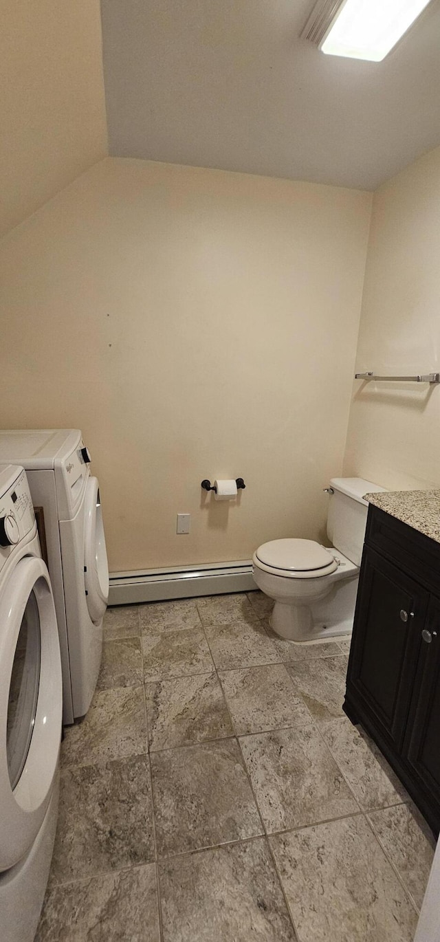 35 Mathews Ave Unit 6, Waterville, ME 04901 - bathroom with washing machine and clothes dryer, a baseboard heating unit, vaulted ceiling, and vanity