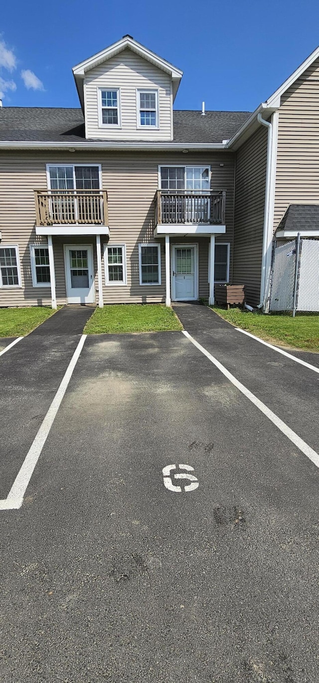 35 Mathews Ave Unit 6, Waterville, ME 04901 - view of front of house with a balcony, roof with shingles, and uncovered parking