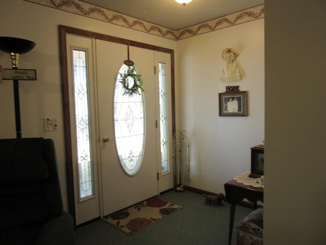 242 Newport Rd, Corinna, ME 04928 - carpeted entrance foyer featuring a wood stove and plenty of natural light
