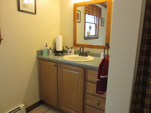 242 Newport Rd, Corinna, ME 04928 - full bath featuring a baseboard heating unit, vanity, and tile patterned floors