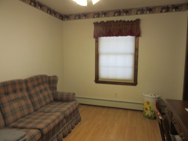 242 Newport Rd, Corinna, ME 04928 - living area featuring a baseboard radiator and wood finished floors