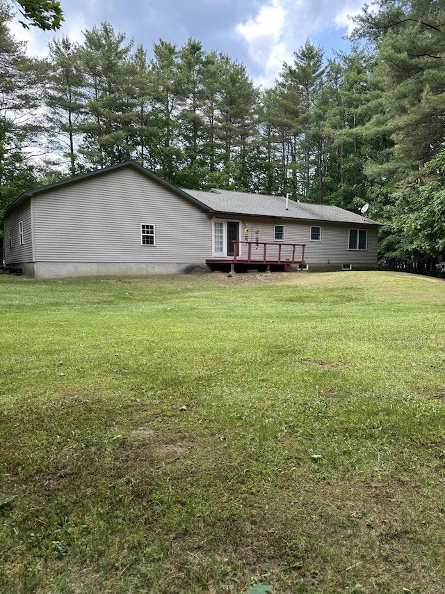 242 Newport Rd, Corinna, ME 04928 - rear view of house with a wooden deck, a lawn, view of wooded area, and crawl space