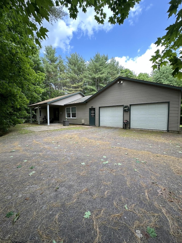 242 Newport Rd, Corinna, ME 04928 - ranch-style home with asphalt driveway and an attached garage