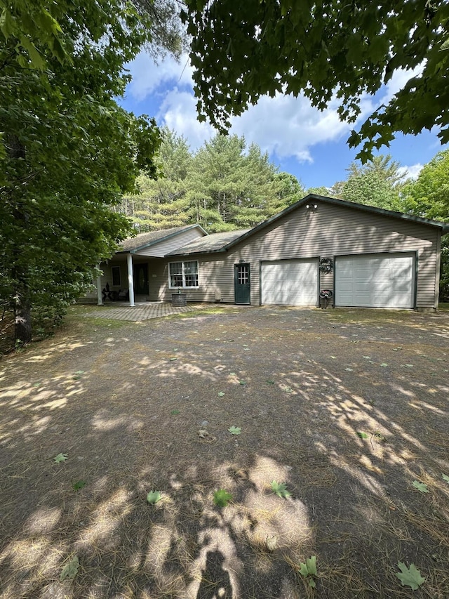 242 Newport Rd, Corinna, ME 04928 - view of front facade with driveway, a porch, and a garage