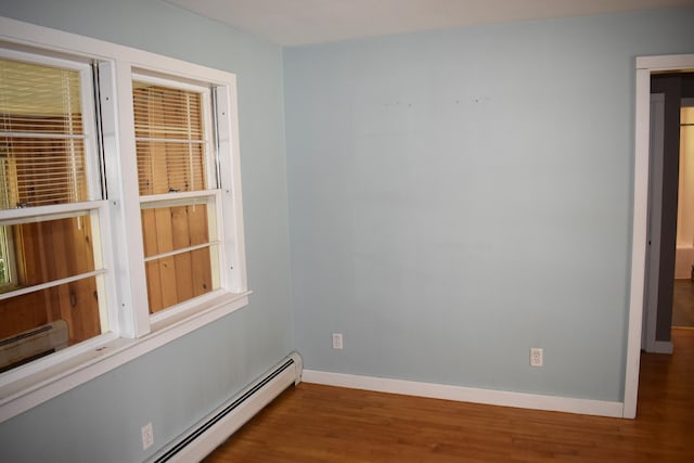 25 Ariel St, Lincoln, ME 04457 - unfurnished room with a baseboard heating unit, wood finished floors, and a baseboard radiator