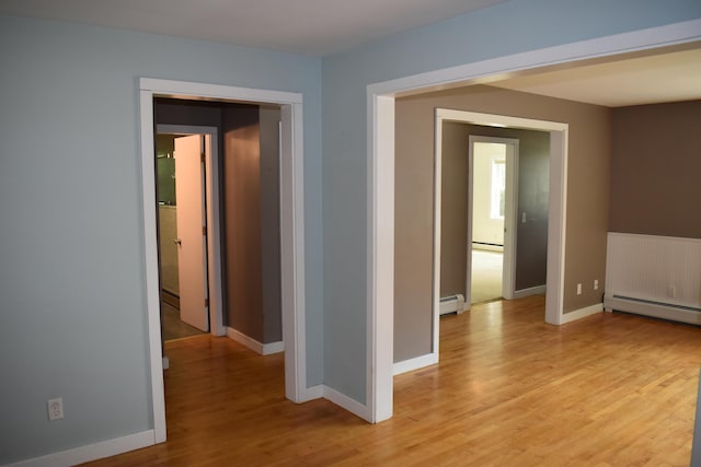 25 Ariel St, Lincoln, ME 04457 - hall with a baseboard radiator, light wood finished floors, and baseboard heating