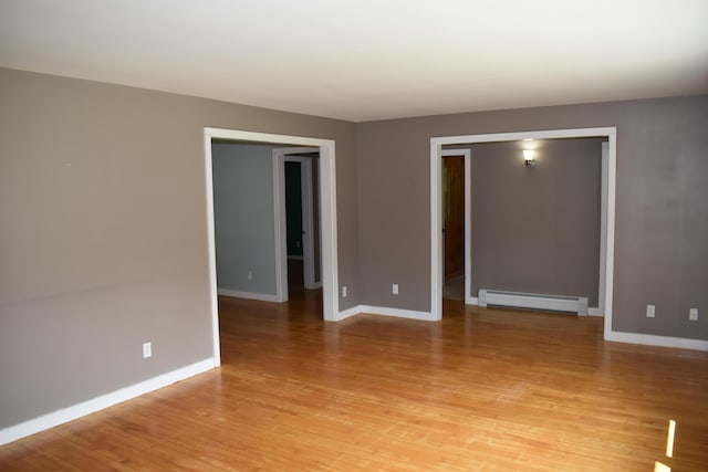 25 Ariel St, Lincoln, ME 04457 - spare room with baseboard heating and light wood-style floors