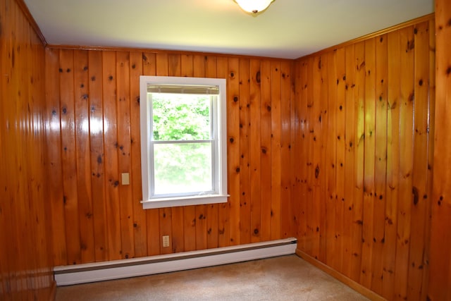 25 Ariel St, Lincoln, ME 04457 - carpeted empty room with a baseboard heating unit and wooden walls