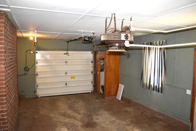 25 Ariel St, Lincoln, ME 04457 - garage featuring a garage door opener and baseboards