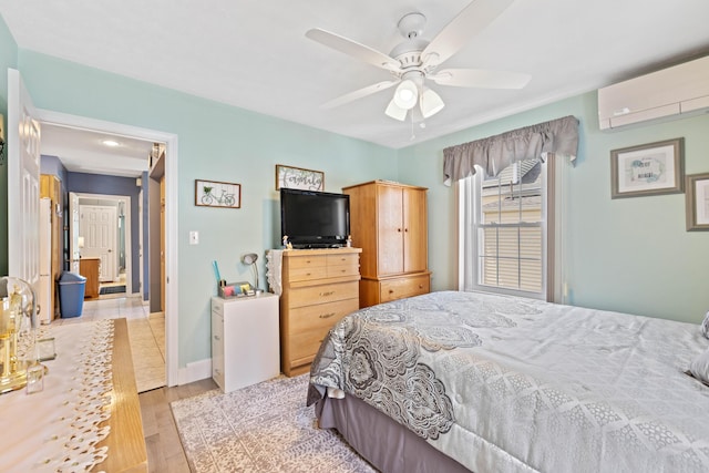 25 Harding St, Biddeford, ME 04005 - bedroom with a wall unit AC, light wood finished floors, and a ceiling fan