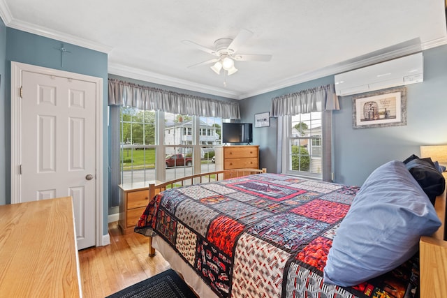 25 Harding St, Biddeford, ME 04005 - bedroom featuring ornamental molding, wood finished floors, a ceiling fan, and a wall unit AC