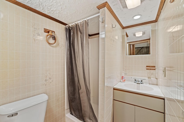 25 Harding St, Biddeford, ME 04005 - full bath featuring tile walls, crown molding, vanity, a textured ceiling, and shower / bath combo