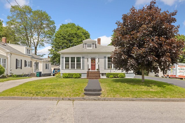 25 Harding St, Biddeford, ME 04005 - view of front of home featuring entry steps, a chimney, a front lawn, and roof with shingles