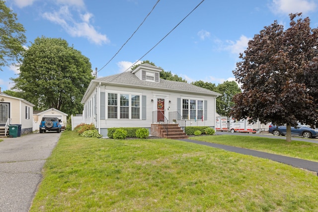 25 Harding St, Biddeford, ME 04005 - view of front of house featuring a front yard, a detached garage, and an outdoor structure